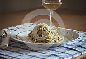 Spaghetti with Pesto Genovese and Pecorino Romano cheese glass of Vernaccia tuscany white wine