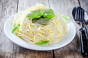 Spaghetti with pesto sauce and basil