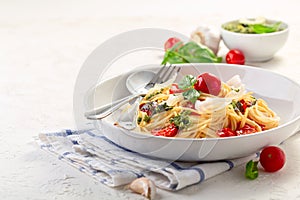 Spaghetti with pesto sauce, fresh basil and cherry-tomatoes