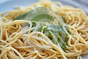 Spaghetti and pesto sauce are on the plate