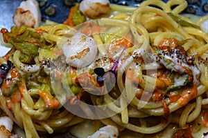 Spaghetti pie with cod and courgette flowers