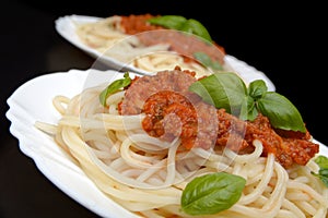 Spaghetti ragu alla bolognese sauce on black,close up