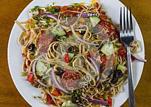 Spaghetti salad with mixed vegetables and top with shreded cheese