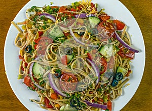 Spaghetti salad with mixed vegetables and top with shreded cheese