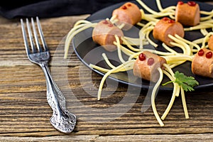 spaghetti with sausages in the form of spiders. Happy kid food for Halloween party