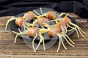 spaghetti with sausages in the form of spiders. Happy kid food for Halloween party