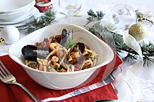 Spaghetti with seafood. Christmas festive table setting for the festive dinner with dishes.