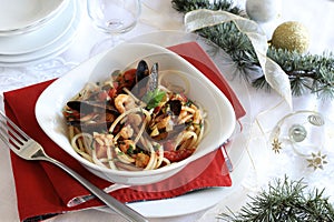 Spaghetti with seafood. Christmas festive table setting for the festive dinner with dishes.