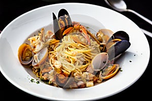 Spaghetti seafood with mussels and shrimps and tomatoes, with parsley