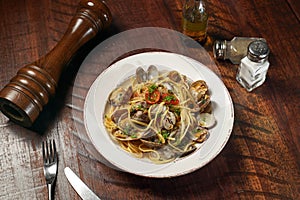 Spaghetti with Spicy Garlic and Clams Vongole served in dish isolated on wooden table top view of italian fast food