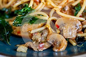 Spaghetti with Spicy Mixed mushroom and basil.Thai fusion food.