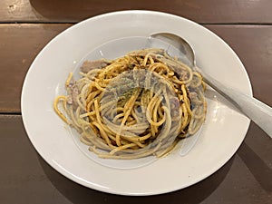 Spaghetti with spicy tuna sauce and oregano served on a plate