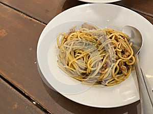 Spaghetti with spicy tuna sauce and oregano served on a plate