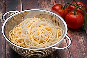 Spaghetti in a stainless steel collander