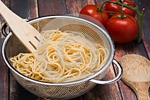 Spaghetti in a stainless steel collander
