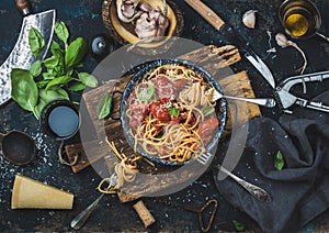 Spaghetti with tomato and basil and ingredients for making pasta