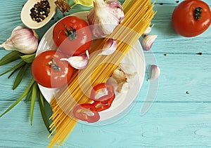 spaghetti, tomato, garlic pepper dinner nutrition plate recipe vegetable on a blue wooden background