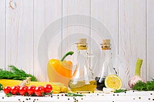 Spaghetti, tomatoes cherry, olive oil, herb and spices on old white wooden background. Set for healthy foods. Ingredients for sala