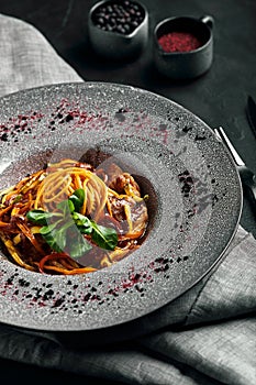 Spaghetti with vegetables tomato sauce and meat. Traditional italian food. Food photo. Dish from the chef. Beautiful