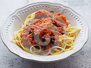 Spaghetti with vegetarian soy bolognese on white rustic background