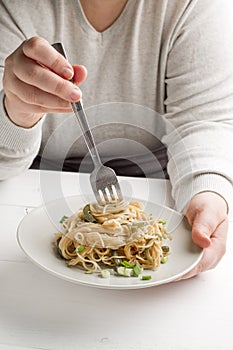 spaghetti on white plate with green onion