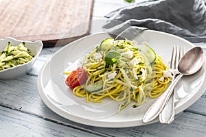 Spaghetti zucchini raw vegan pasta with feta cheese cucumber and basil