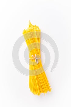 Spaghettini - thinner Spaghetti. Raw Spaghetti on white background
