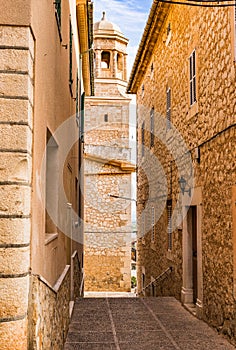 Spain, alley with church steeple of mediterranean village on Majorca