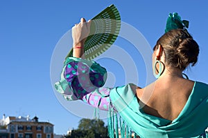 The back woman with flamenco dress and fan photo