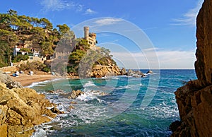 Spain. Coast of the Costa Brava. Catalonia. Lloret de Mar. Mediterranean Sea. Beautiful rocks. A sea wave hits the shore
