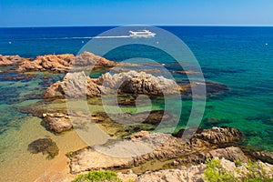 Spain, Costa Brava coastline. Mediterranean seascape with white yacht