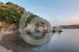 Spain Costa Brava peaceful pebble beach of the Mediterranean sea, Cala Guillola, Cadaques, Cap de Creus, Catalonia