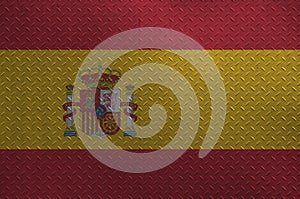Spain flag depicted in paint colors on old brushed metal plate or wall closeup. Textured banner on rough background