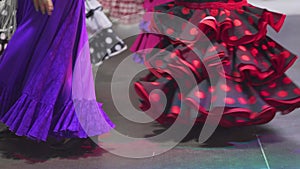 Spain - Flamenco. Women in traditional dresses dancing flamenko.