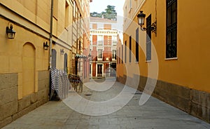 Spain, Madrid, 3 Calle del Biombo, narrow street and view of the red house photo