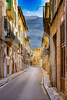 Spain Majorca, street with mediterranena old houses and mountain landscape in Soller village