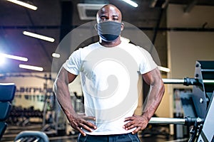 spain man in white cotton t-thirt wearing mask while working out in gym