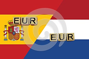 Spain and Netherlands currencies codes on national flags background