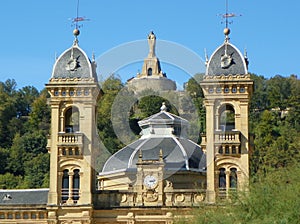 Spain, San Sebastian, Alderdi Eder park, two towers City Hall and the view of the statue of the Sacred Heart of Jesus