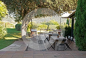 Spain. Summer area of a beautiful restaurant. Spanish cafe tables. Lots of empty tables, chairs on cozy seating area