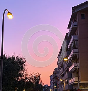 Spain sunset with lampposts and buildings