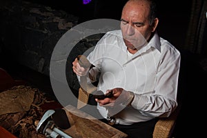 SPAIN, TENERIFE, ABAMA RITZ, FEBRUARY 2016: Torcedor rolling hand made cigars parejos