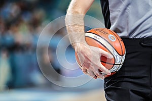 Basketball referee with official orange ball