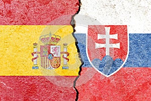 Spain vs Slovakia flags on cracked wall