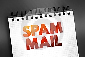 Spam mail - unsolicited and unwanted junk email sent out in bulk to an indiscriminate recipient list, text concept on notepad