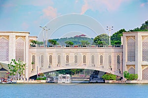 Span of arched bridge over the river. View of the water bridge, shipping construction.