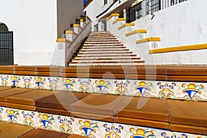 Spanish architecture style buildings with whitewashed walls and beautiful colorful tiled stairs