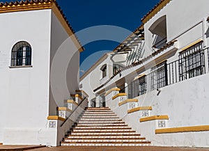 Spanish architecture style buildings with whitewashed walls and beautiful colorful tiled stairs