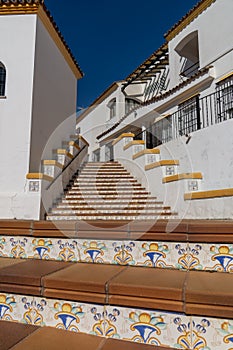 Spanish architecture style buildings with whitewashed walls and beautiful colorful tiled stairs