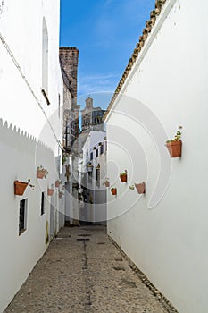 Spanish architecture style buildings with whitewashed walls and flower pots on the walls